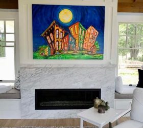 stone fireplace with painting