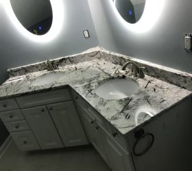 bathroom countertops with lights on the mirror